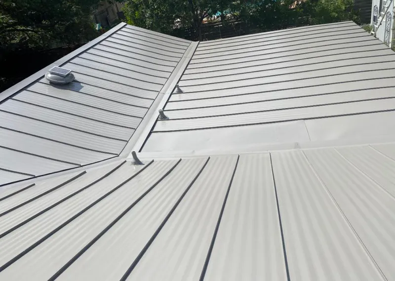 Solar attic fan installed on a metal roof for Roof Ventilation in Alachua