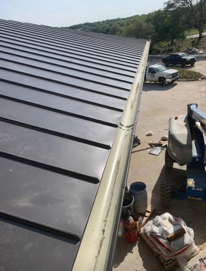 Standing seam panel and gutter detail on a metal roofing jobsite in Alachua